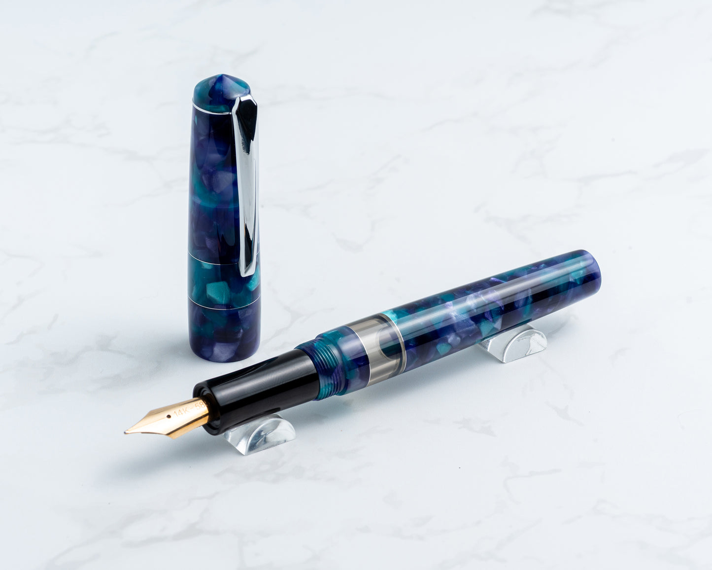 Fountain pen with a blue and black design on a light gray background