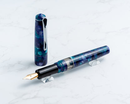 Fountain pen with a blue and black design on a light gray background