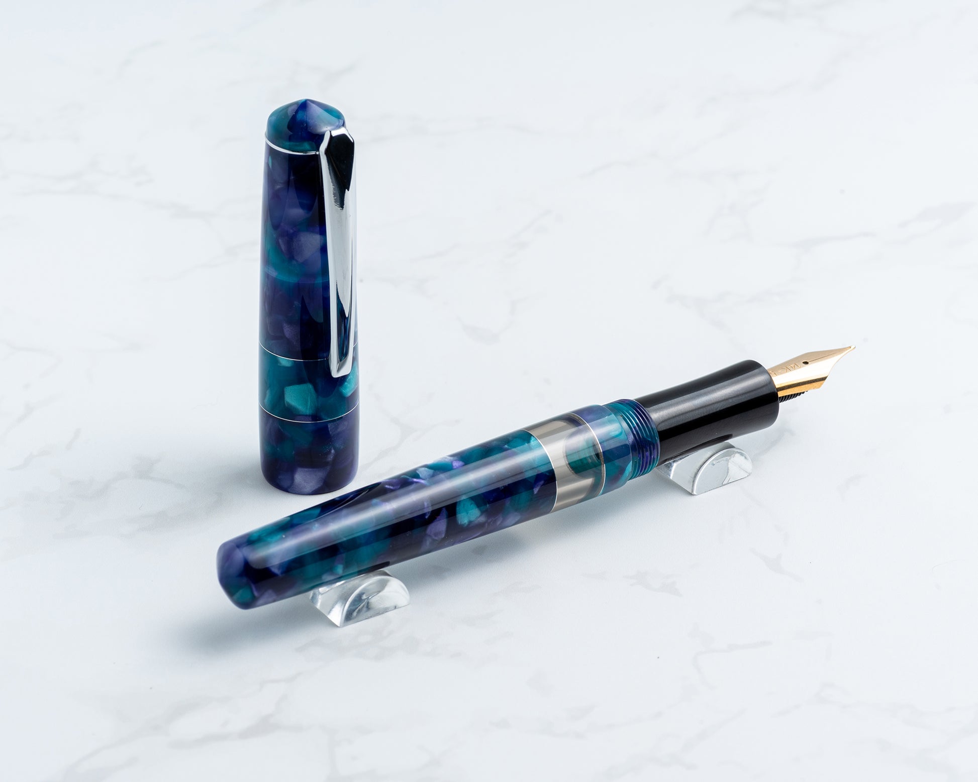 Fountain pen with blue and purple marbled design on a white background