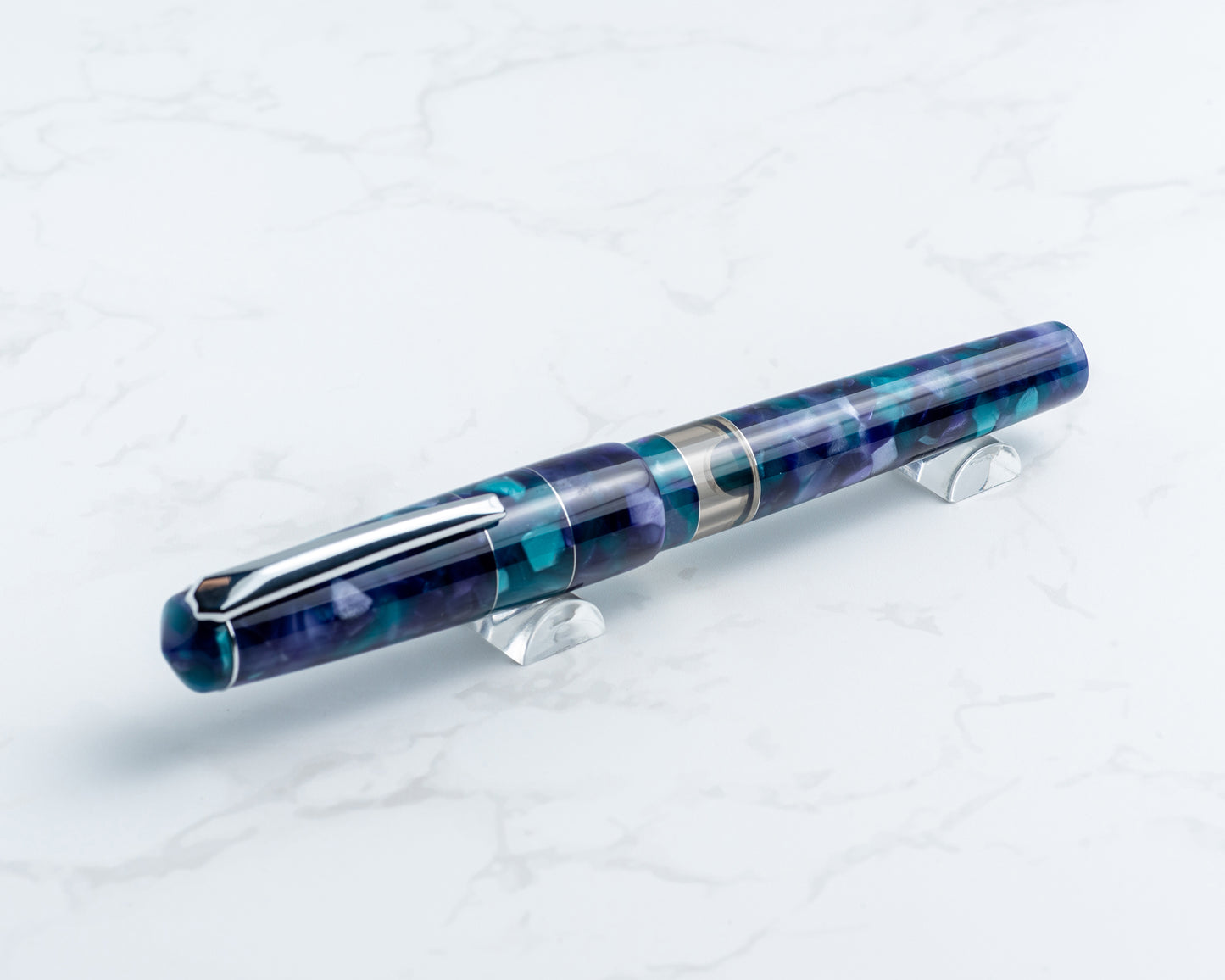 Blue and purple pen on a white stand with a white background