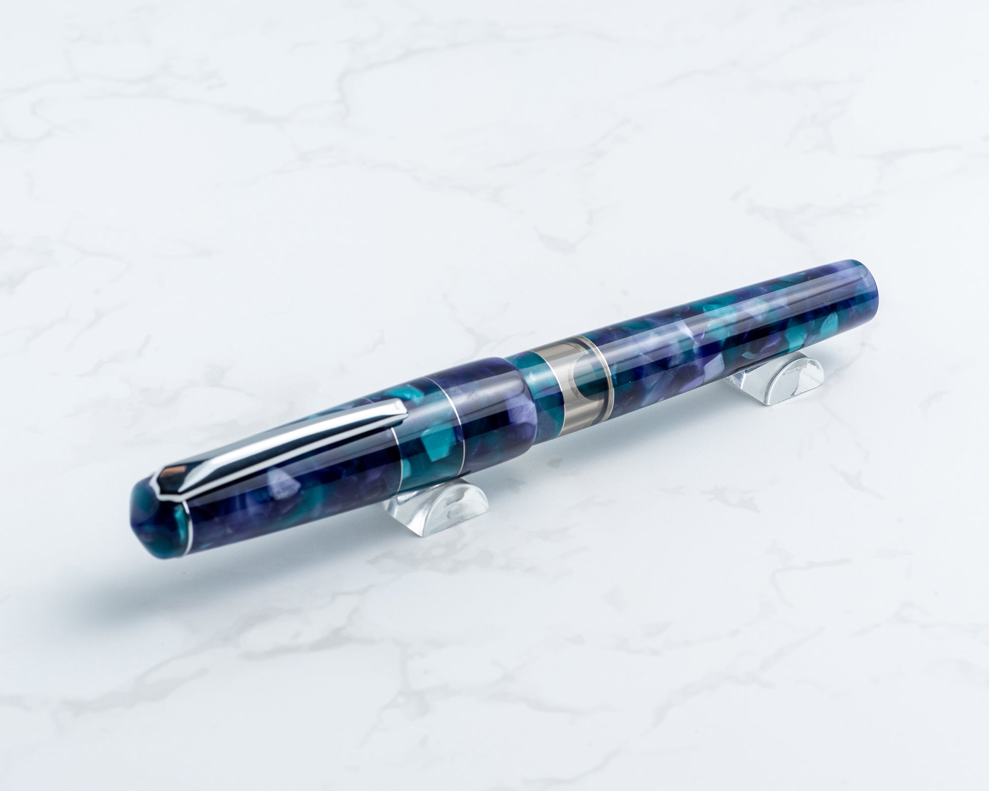 Blue and purple pen on a white stand with a white background