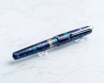 Blue and silver pen on a white stand against a white background